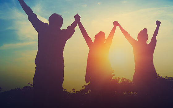 People lifting their hands in celebration